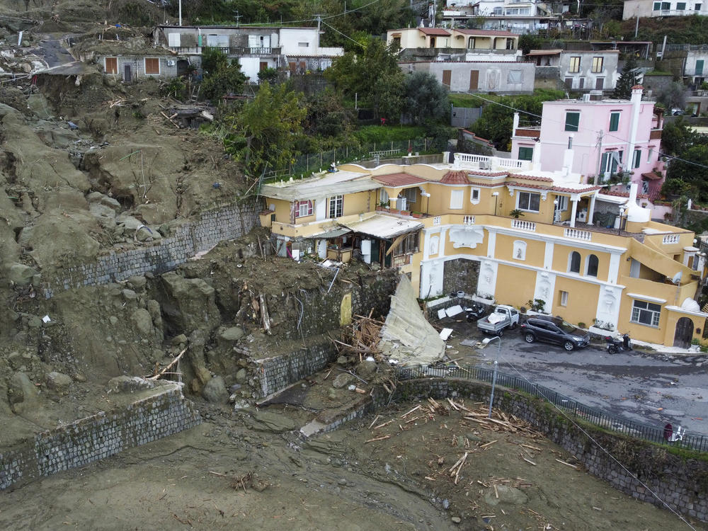 An aerial view of damaged houses after heavy rainfall triggered landslides that collapsed buildings and left as many as 12 people missing, in Casamicciola, on the southern Italian island of Ischia, Sunday, Nov. 27, 2022.