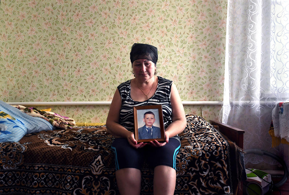 Oksana Breus holds a photo of her son, Oleksandr, at her home in Bobrovytsia.
