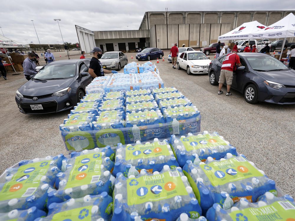 Volunteers distribute food and water Wednesday, Feb. 24, 2021, in Houston. The City of Houston, in collaboration with CrowdSource Rescue, Operation BBQ Relief and the Salvation Army served hot meals to those still impacted by Severe Winter Storm Uri.