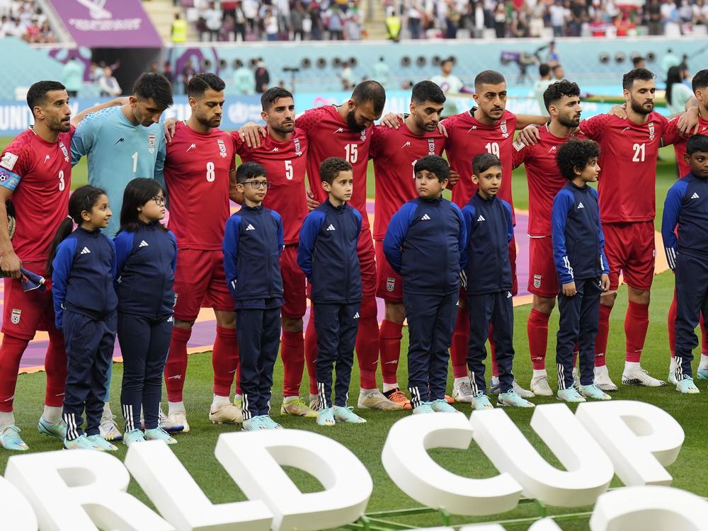 The team of Iran standing on the pitch waiting for the national anthem prior to the the match against England on Nov. 21. The team stayed silent during the anthem in apparent solidarity with protesters.