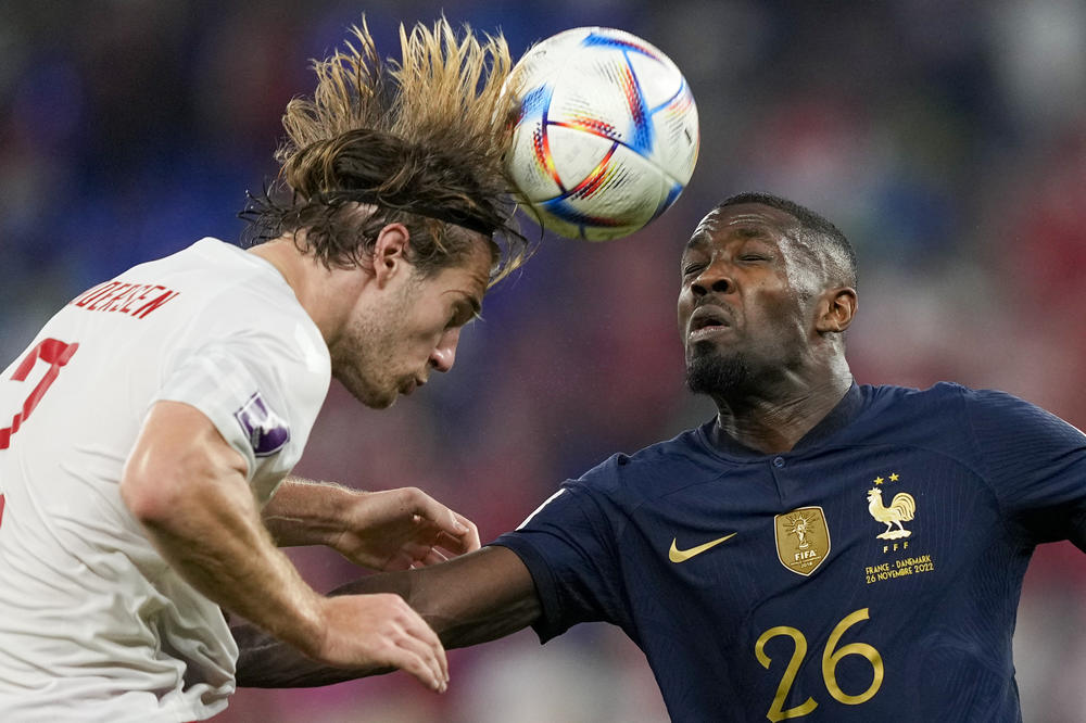 Denmark's Joachim Andersen, left, and France's Marcus Thuram go for a header during a 2022 World Cup Group D match on Saturday, Nov. 26, 2022, at Stadium 974 in Doha, Qatar.