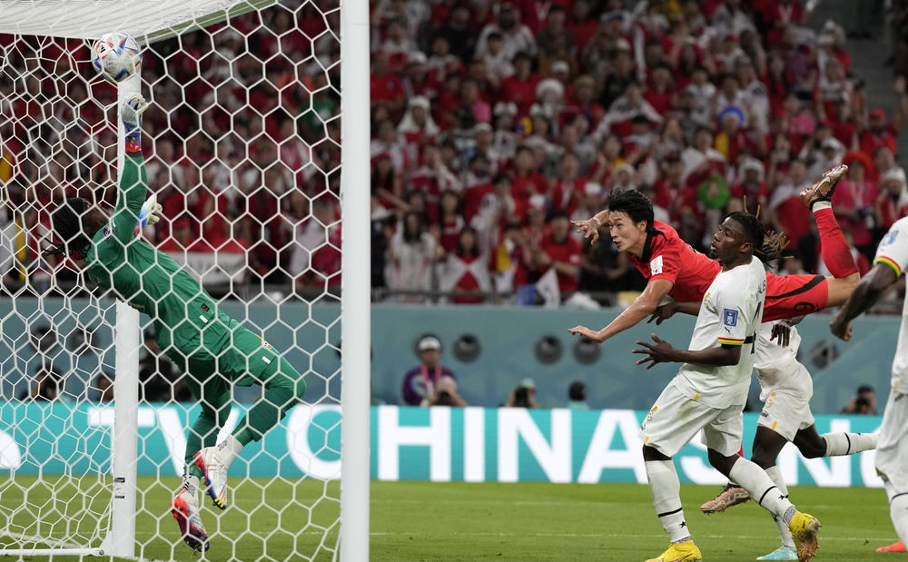 South Korea's Cho Gue-sung heads the ball past Ghana's goalkeeper, Lawrence Ati-Zigi, to score his team's second goal during a 2022 World Cup Group H match on Monday, Nov. 28, 2022, at the Education City Stadium in Al Rayyan, Qatar.