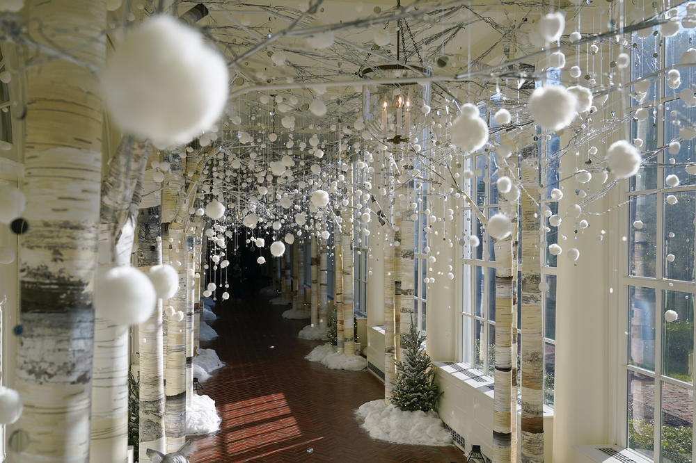 The East Colonnade of the White House is decorated with winter trees, animals and lanterns.