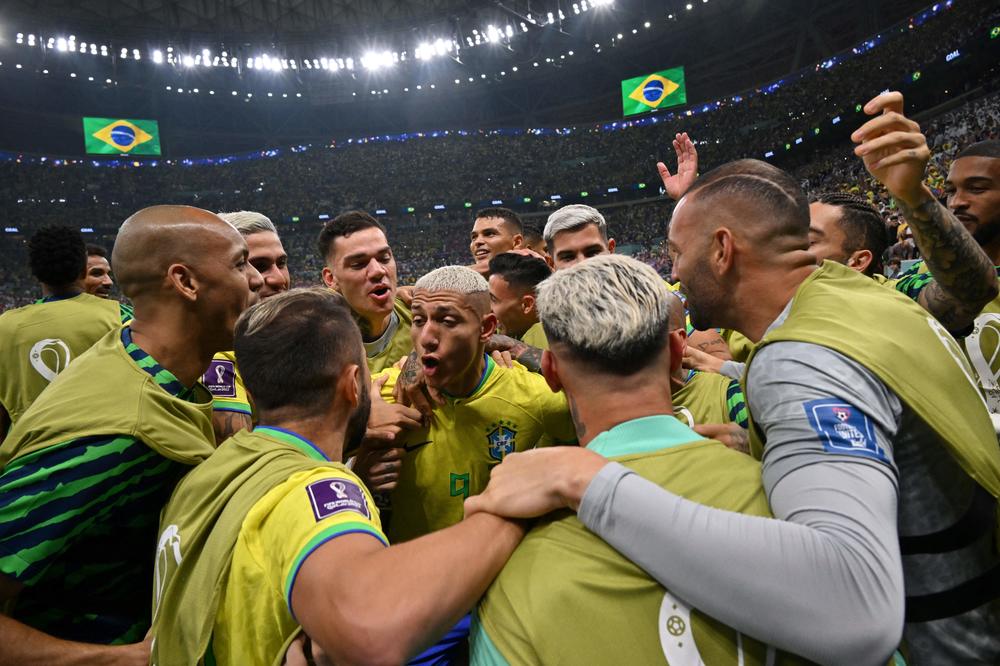 Brazilian forward Richarlison (center, No. 9) celebrates with his teammates after scoring his team's second goal during a 2022 World Cup Group G match against Serbia on Thursday, Nov. 24, 2022, at the Lusail Stadium in Lusail, north of Doha, Qatar.