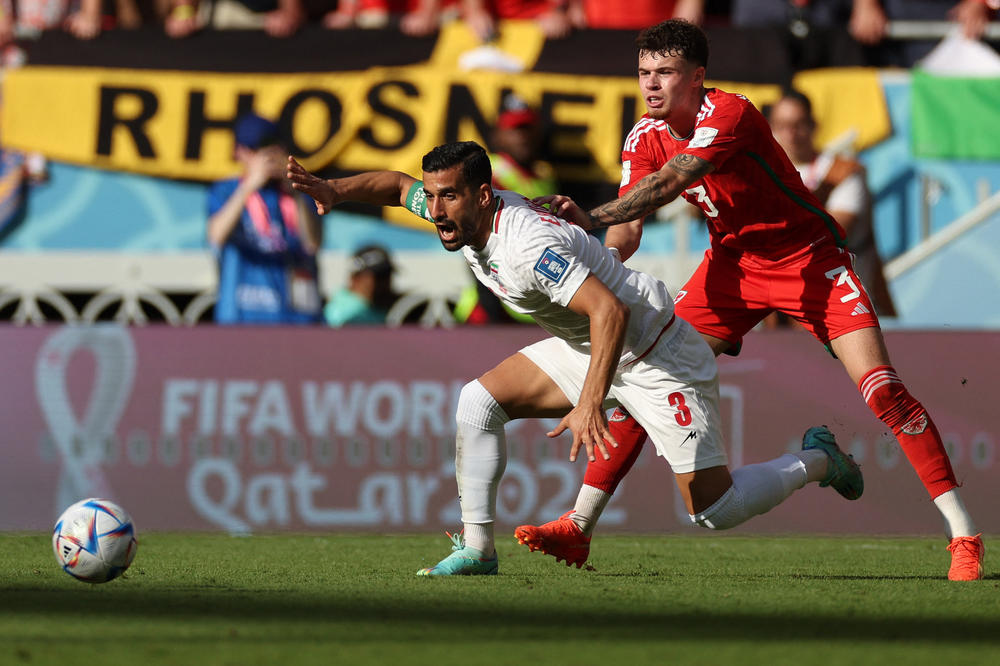 Iranian defender Ehsan Hajsafi (No. 3) fights for the ball with Wales defender Neco Williams (No. 3) during a 2022 World Cup Group B match on Friday, Nov. 25, 2022, at the Ahmad Bin Ali Stadium in Al-Rayyan, west of Doha, Qatar.