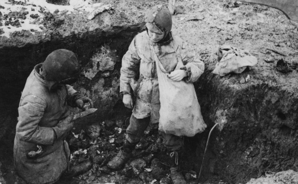 Two boys fill a sack with potatoes that had been hidden during Ukraine's devastating famine in the 1930s.