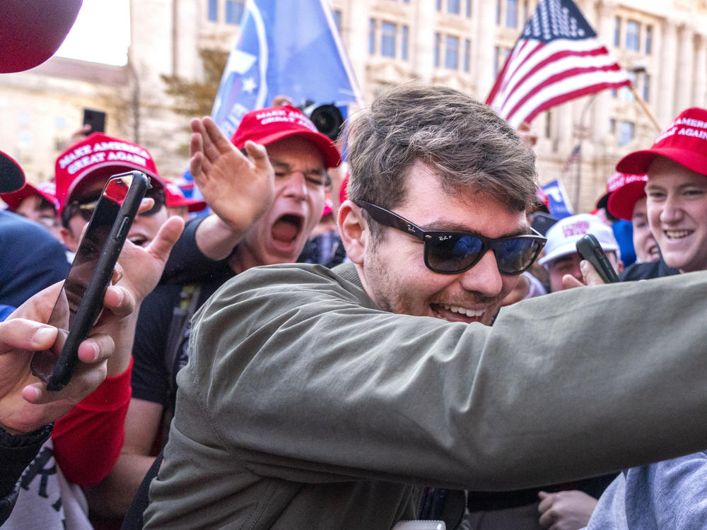 Nick Fuentes (center) greets supporters before speaking at a pro-Trump march on Nov. 14, 2020, in Washington. Fuentes, who has been labeled a white supremacist and antisemite by the Anti-Defamation League, sat down for dinner with former President Trump and Ye, the rapper formerly known as Kanye West, last week.