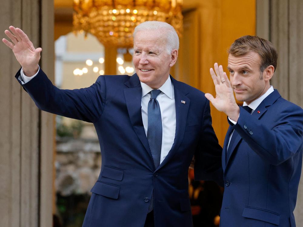 French President Emmanuel Macron welcomes President Biden before their meeting at the French Embassy to the Vatican in Rome on Oct. 29, 2021.
