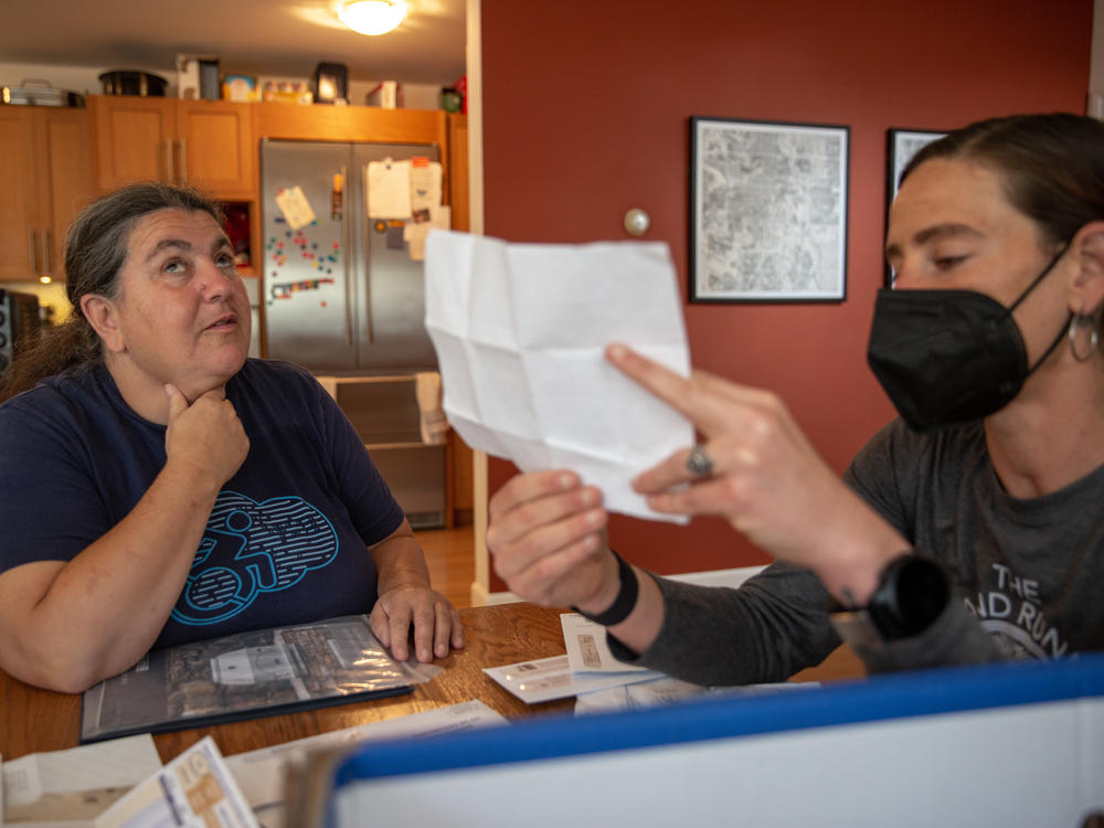 Lucy Greco (left), a web-accessibility specialist at the University of California, Berkeley, is blind. She reads most of her documents online, but employs Liza Schlosser-Olroyd as an aide to sort through her paper mail every other month, to make sure Greco hasn't missed a bill or other important correspondence.