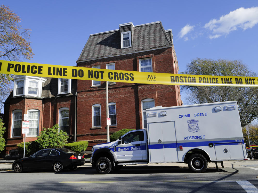 A Boston Police Crime Scene Response vehicle is parked on the street outside an apartment building where infant and other human remains were discovered by authorities.