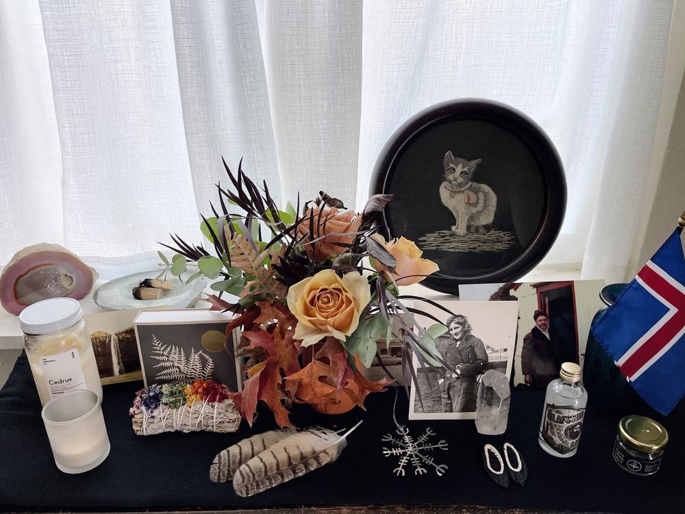 Lilja Klempan's ancestral altar pays homage to her Icelandic culture. She has an Icelandic flag, photos of her grandparents, flowers and a cat that her maternal grandmother, Kristín Elín Théodórsdóttir, embroidered in 1929.