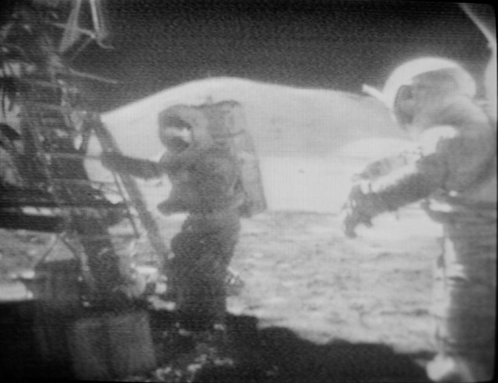 This image taken from a TV transmission shows Harrison Schmitt starting back up the ladder of the lunar module on December 14, 1972. Eugene Cernan, standing nearby, is about to take the final steps on the moon.