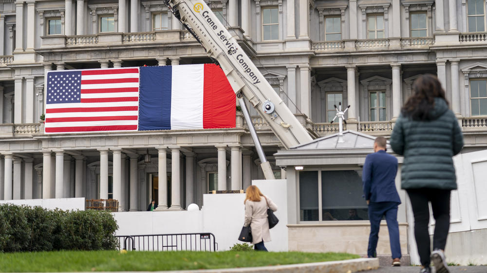 American and French flags are in place on the Old Executive Office Building on the White House campus on Tuesday in Washington in advance of the state visit by French President Emmanuel Macron.