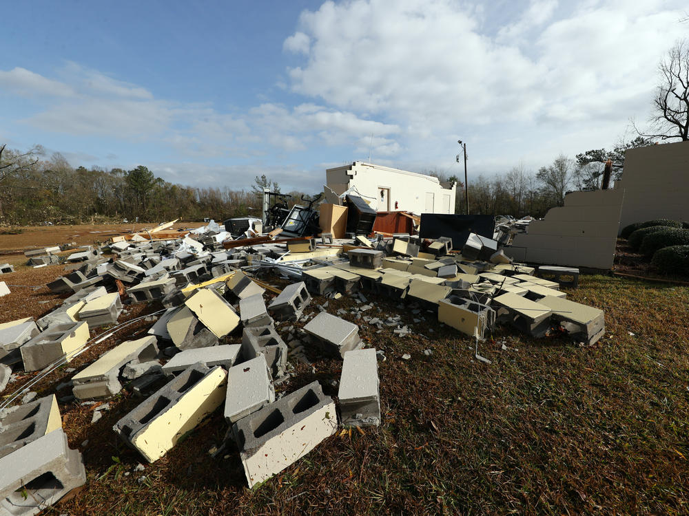 Cinder blocks from the Flatwood Community Center are strewn about Wednesday in Flatwood, Ala., following a severe storm.