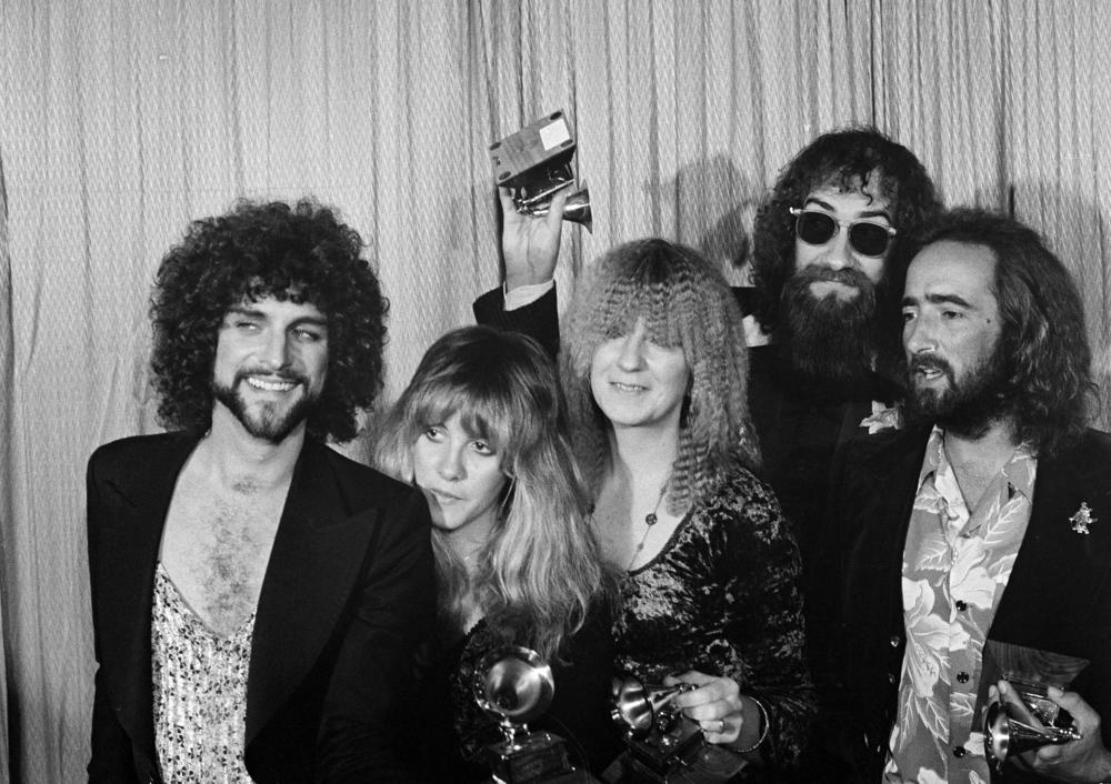 Members of Fleetwood Mac (from left) Lindsey Buckingham, Stevie Nicks, Christine McVie, Mick Fleetwood and John McVie pose with their Album of the Year Grammy Award for 