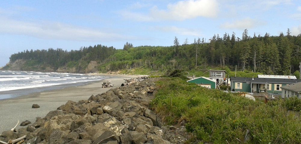 In this photo taken May 28, 2014, houses in the village of Taholah, on the Quinault Indian Reservation on the Pacific are shown at right. Repairs were made to the storm-damaged seawall that protects the village back in 2014, but continued erosion is forcing the community to move elsewhere.