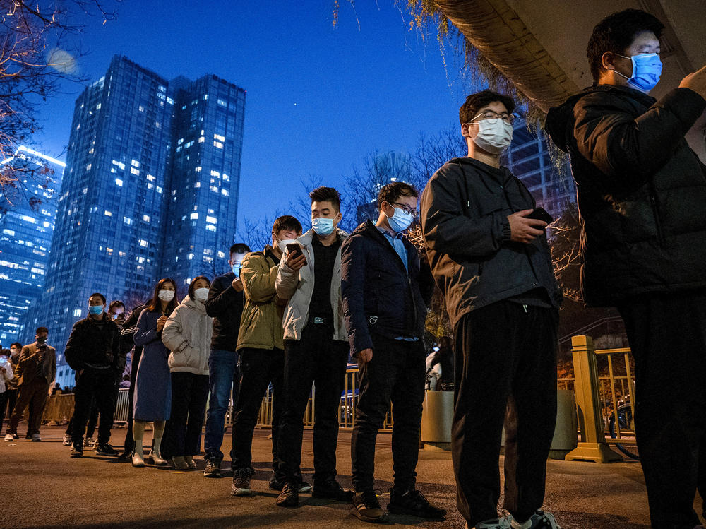 China is doing many millions of tests a day to uncover cases of COVID-19 — part of its zero-COVID policy. Above: People line up for nucleic acid tests to detect the virus at a public testing site on Nov. 17 in Beijing.