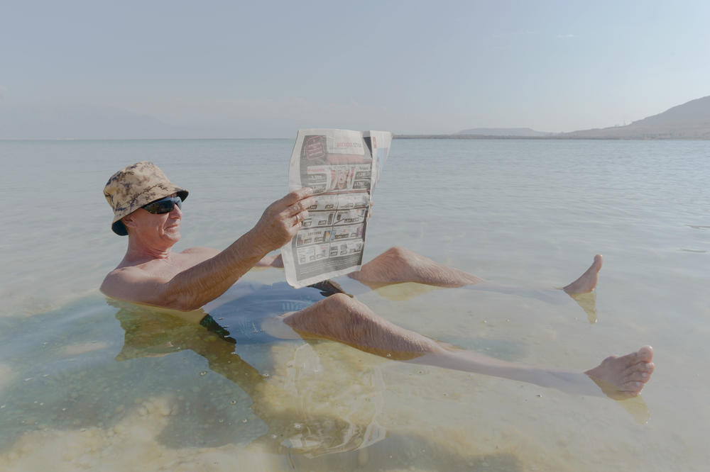 Gregory, a recent immigrant from Russia, floats in the Dead Sea at a beach connected to an Israeli hotel resort on Nov. 10. The water of the lake is so full of salt that bathers float right to the top.