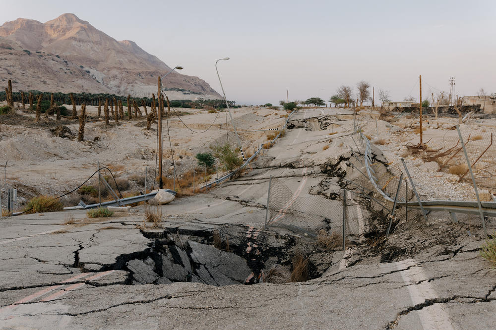 A large sinkhole in the middle of the road in the Ein Gedi area west of the Dead Sea in Israel on Nov 5. Ein Gedi Beach is completely closed to bathers due to the danger of sinkholes.