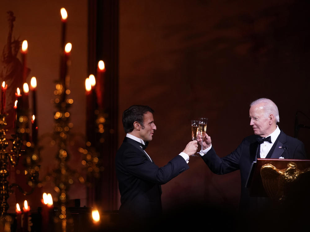 President Biden and French President Emmanuel Macron toast during a state dinner on the South Lawn of the White House in Washington, D.C., on Thursday.