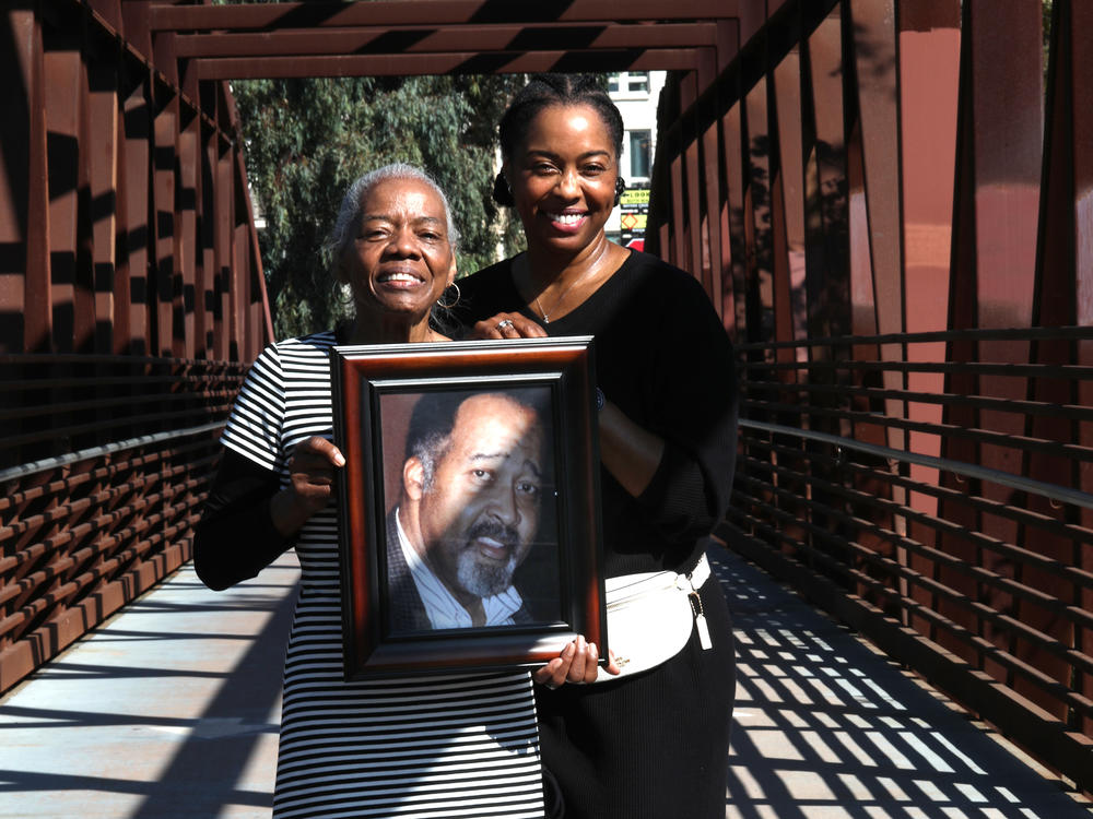 Catherine Lawson (left) and her daughter Karen Lawson (right) hold a picture of Jerry Lawson in San Jose, Calif. in 2020.