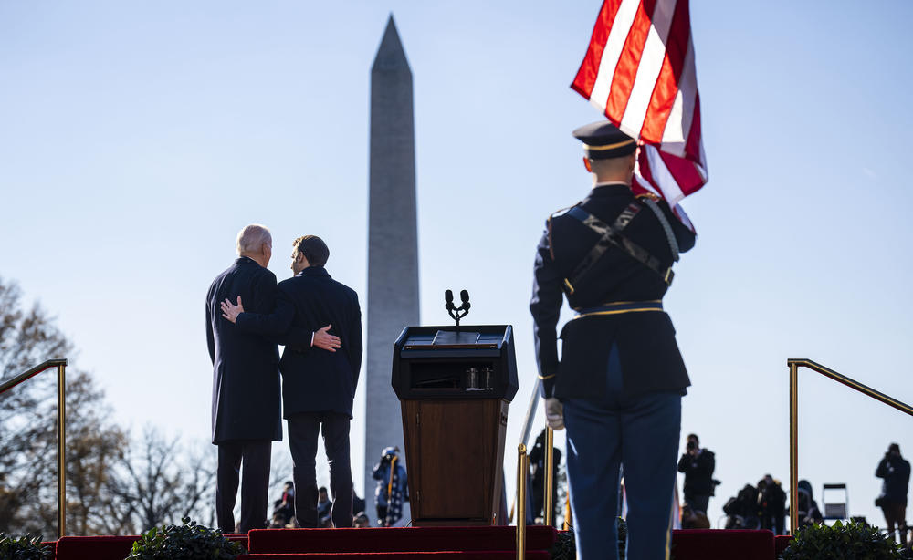 U.S. President Biden (left) and French President Emmanuel Macron stand for their national anthems during an official arrival ceremony at the White House Thursday in Washington, D.C.