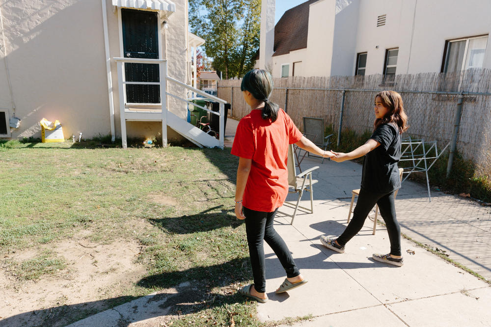 Martha Escudero's daughters, Victoria and Meztli, in the back yard of their home in the El Sereno neighborhood of Los Angeles, Calif. on Nov. 20, 2022.