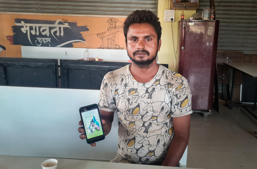 Ashwini Kumar, 24, shows a photo on his phone of his brother Vinod, who died in October 2020 in Qatar, where he was one of the many migrant workers building World Cup stadiums. His family has heard conflicting stories about the cause of death — from a workplace accident to suicide.