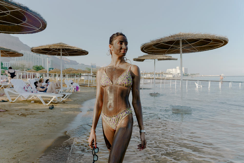 An Israeli visitor at a Dead Sea hotel resort poses with mineral-rich Dead Sea mud lathered on her skin on Nov. 10.