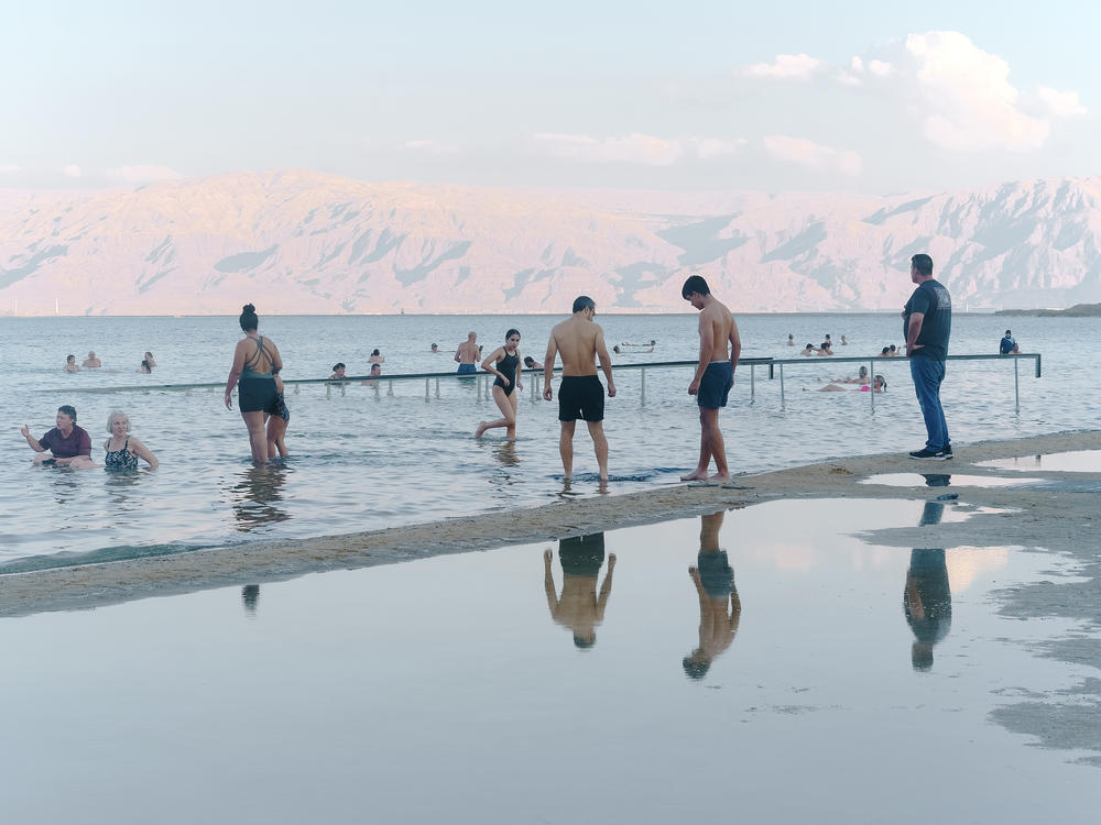 Tourists bathe in the Dead Sea near an Israeli hotel resort on Nov. 10. The lake's southern basin, where Israel's resorts are located, is actually an artificial evaporation pool of Dead Sea water maintained by the Dead Sea Works, an Israeli chemical company that extracts minerals from the lake's water.