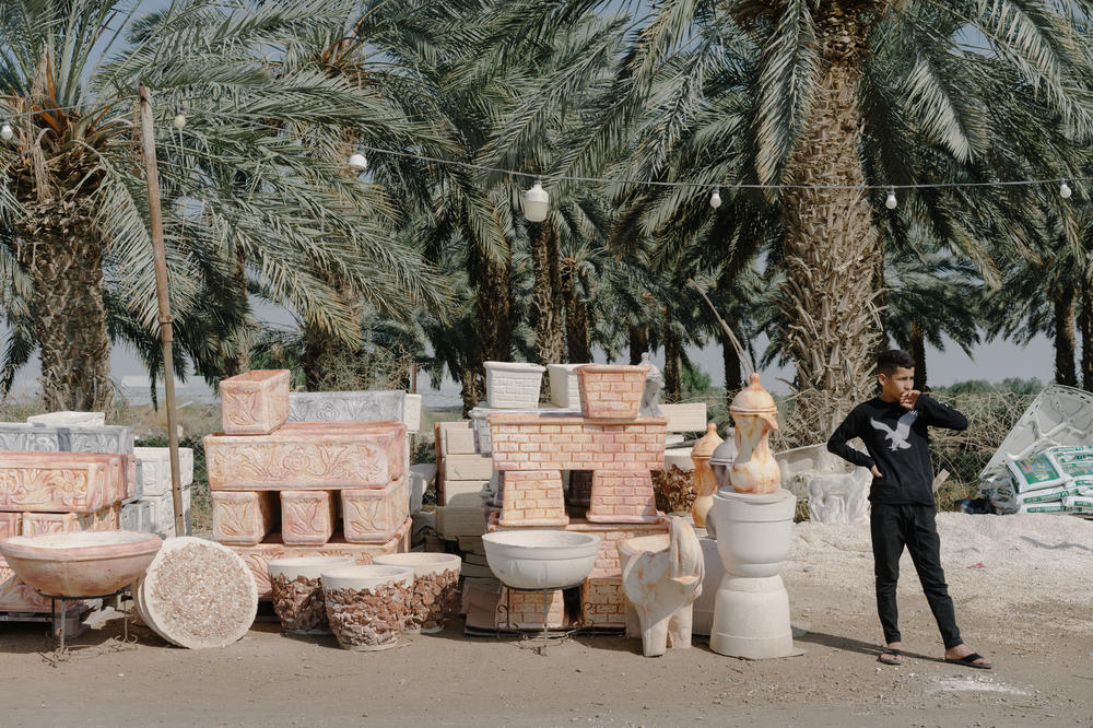 A Palestinian child sells planters and pottery along the road approaching the Dead Sea in the Israeli-occupied West Bank.