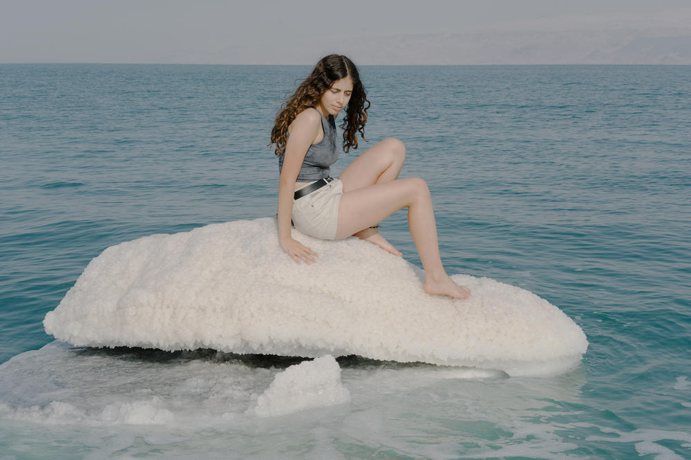 Rachel Kiro, 13, the daughter of Dead Sea researcher Yael Kiro from Israel's Weizmann Institute of Science, sits atop a salt formation in the northern basin of the Dead Sea.