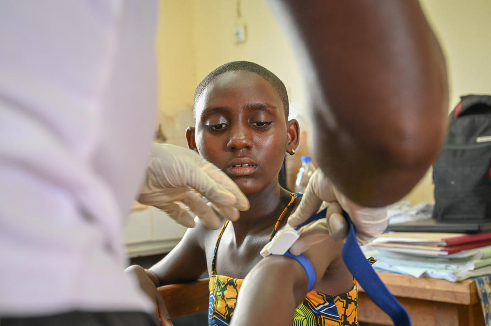 Prisca Dali, 14, who was diagnosed with sleeping sickness after being ill for four years, has her blood drawn during a screening in her village near Sinfra, Ivory Coast.