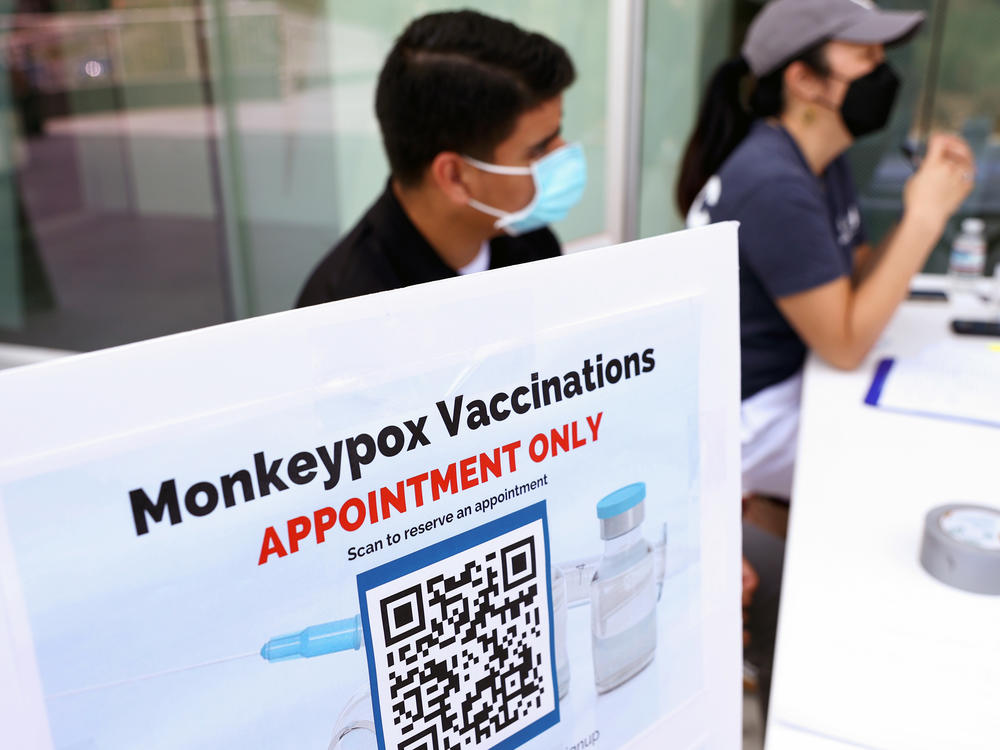 Health workers sit at a check-in table at a pop-up mpox vaccination clinic which opened today by the Los Angeles County Department of Public Health at the West Hollywood Library on August 3, 2022 in West Hollywood, California. California Governor Gavin Newsom declared a state of emergency on August 1st over the mpox outbreak.