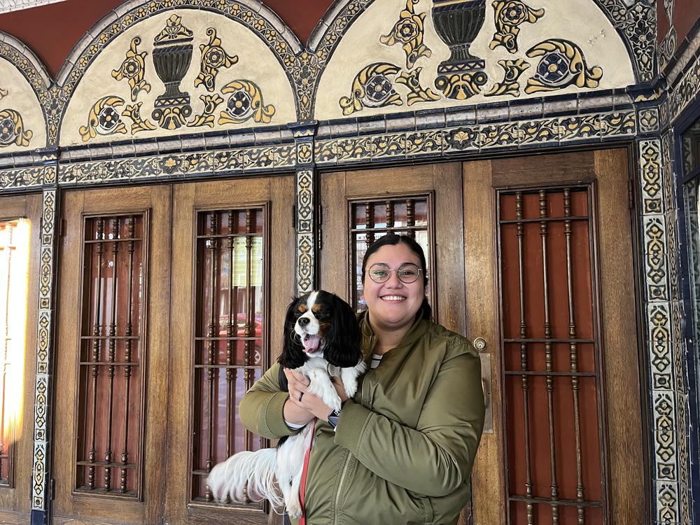 San Francisco resident and movie fan Sophia Padilla poses outside the Castro Theatre with her dog.