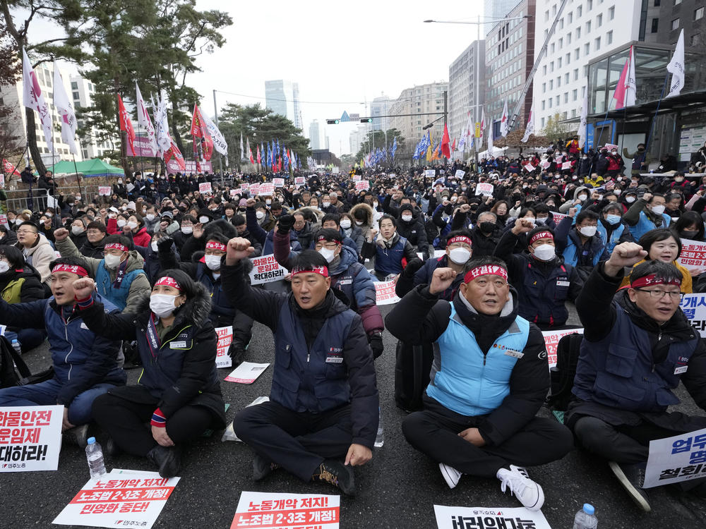 Members of the Korean Confederation of Trade Unions shout slogans during a rally against the government's labor policy near the National Assembly in Seoul on Saturday.