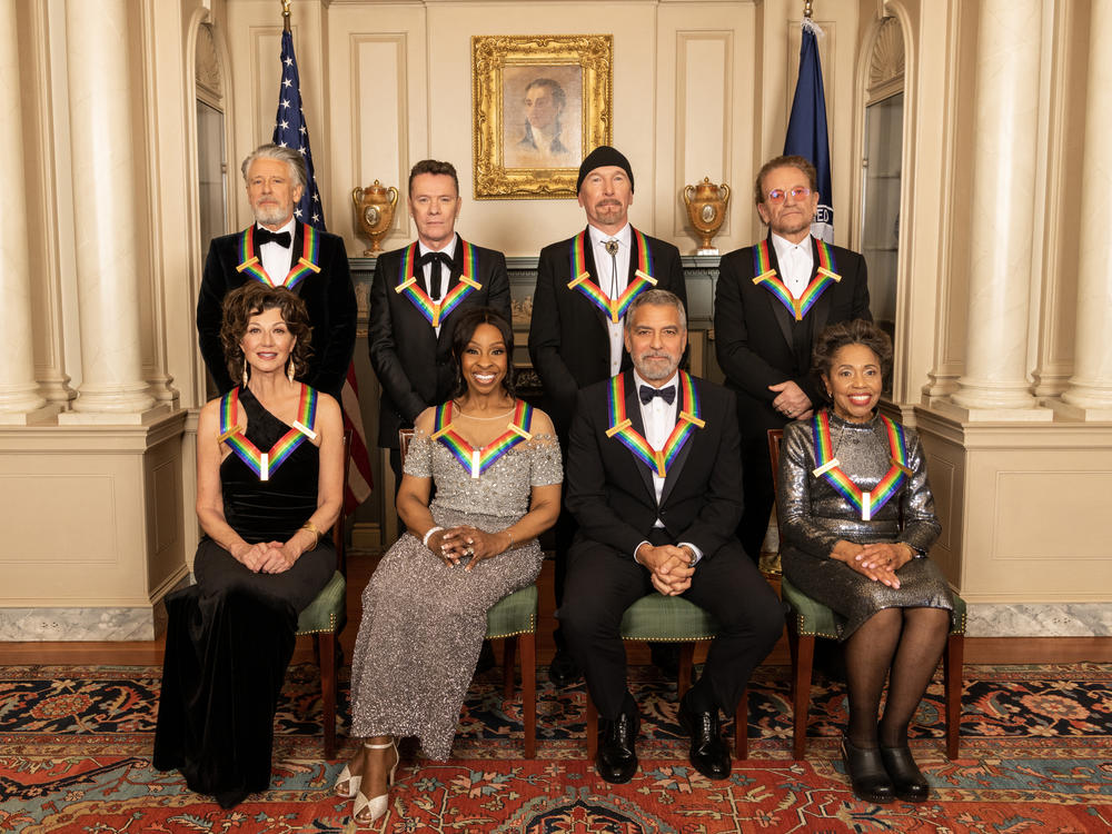 Left to right, back row: U2 members Adam Clayton, Larry Mullen Jr., The Edge and Bono. Front row: Amy Grant, Gladys Knight, George Clooney and Tania León.