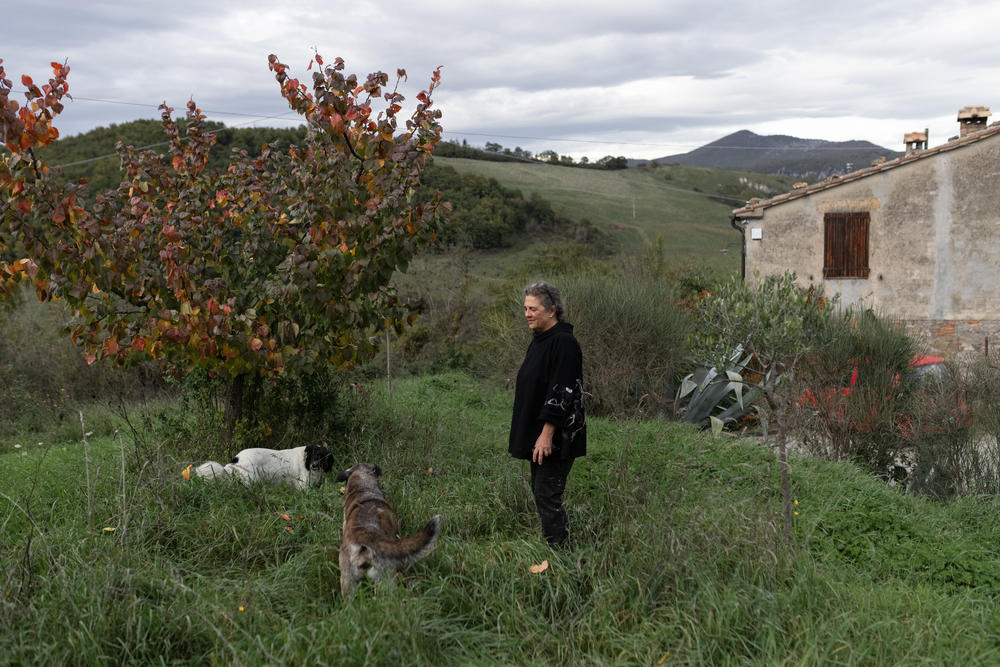 Gloria Lucchesi stands in the yard of her house, on Nov. 12, in San Casciano dei Bagni.