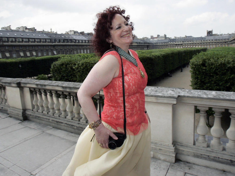 Photographer Nan Goldin poses after being awarded Commander in the Arts and Letters Order, in Paris, June 27, 2006.