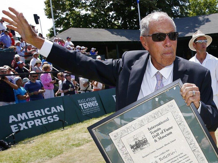 Nick Bollettieri holds his plaque as he waves to the crowd in 2014 after his induction into the International Tennis Hall of Fame in Newport, R.I.