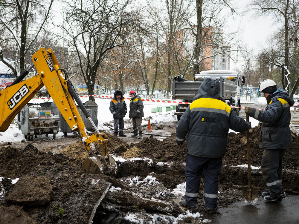 Technicians from DTEK, Ukraine's largest private energy company, work to replace a cable at a substation in the Teremky neighborhood of Kyiv on Wednesday.