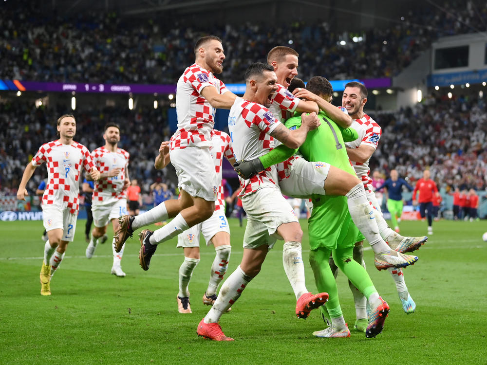 Croatia players celebrate after winning the tournament's first penalty shoot out during the 2022 World Cup round of 16 match between Japan and Croatia at Al Janoub Stadium on December 05, 2022 in Al Wakrah, Qatar.