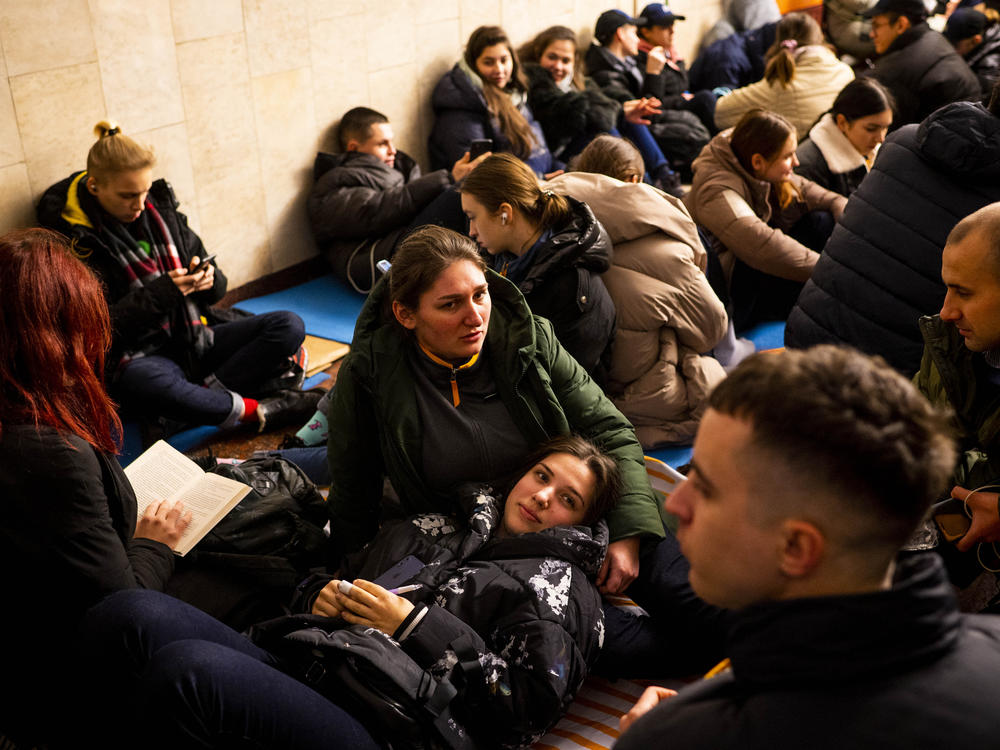 Svitlana (center) and Anastasiya (bottom) take shelter with their McDonald's coworkers in Lva Tolstoho Metro during an air alert in Kyiv on Monday. Russia renewed its missile attacks across Ukraine on Monday.
