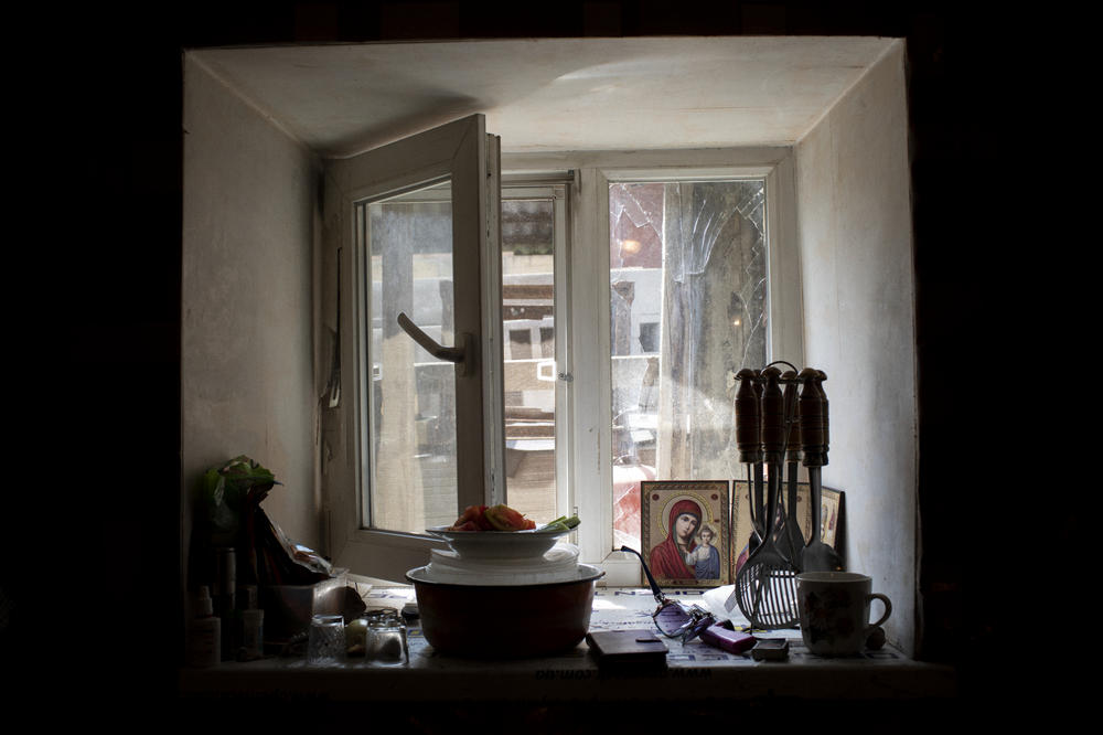 Kitchen windows broken by shelling in Elena Dyachkova and Aleksander Dokalenko's house in old Avdiivka in July 2018. Their property was shelled multiple times over the years.