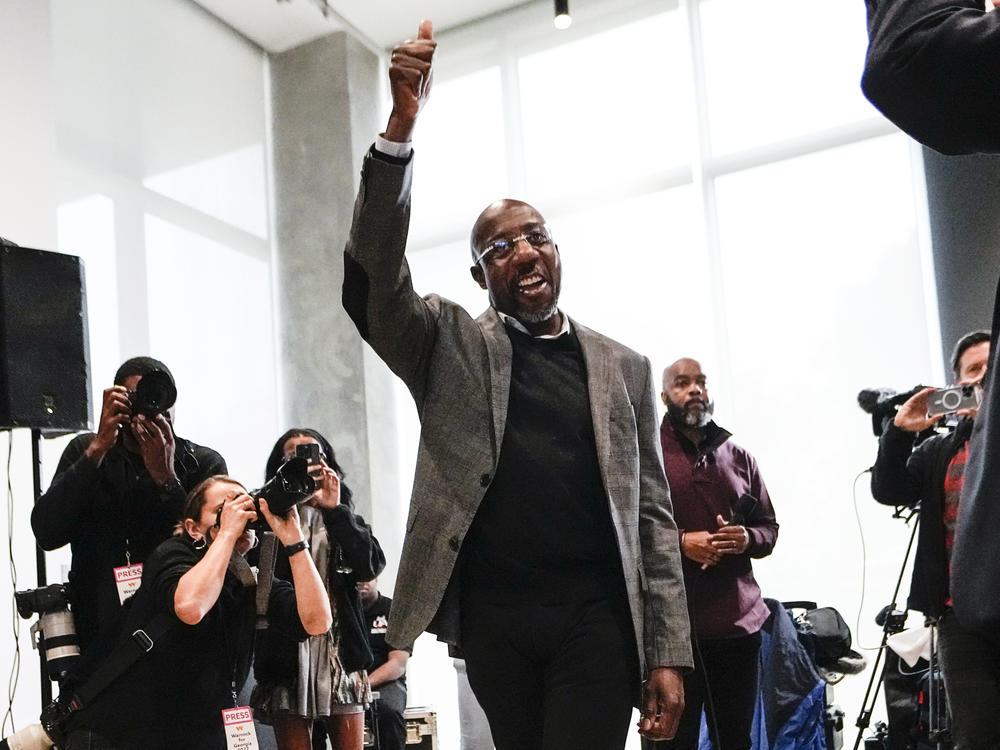 U.S. Sen. Raphael Warnock, D-Ga., waves to supporters as he arrives at a campaign rally Monday at Georgia Tech in Atlanta.