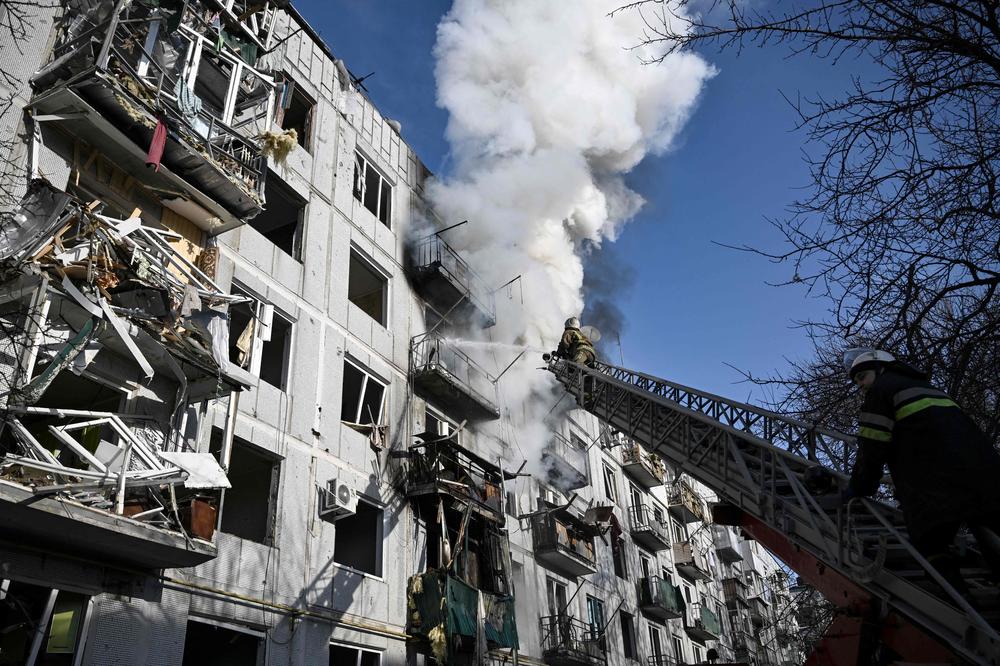 Firefighters respond to a fire in a building after Russian forces bombed the eastern Ukrainian town of Chuguiv on Feb. 24.