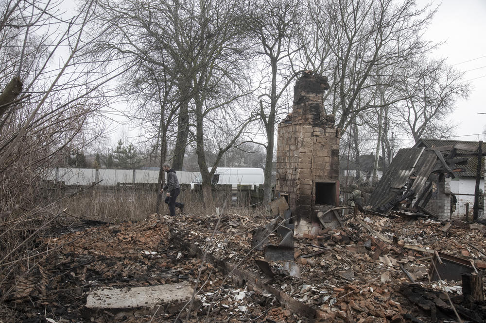 Members of the Ukrainian Territorial Defense Forces walk through Nova Basan after retaking the village from the Russian army on April 1.