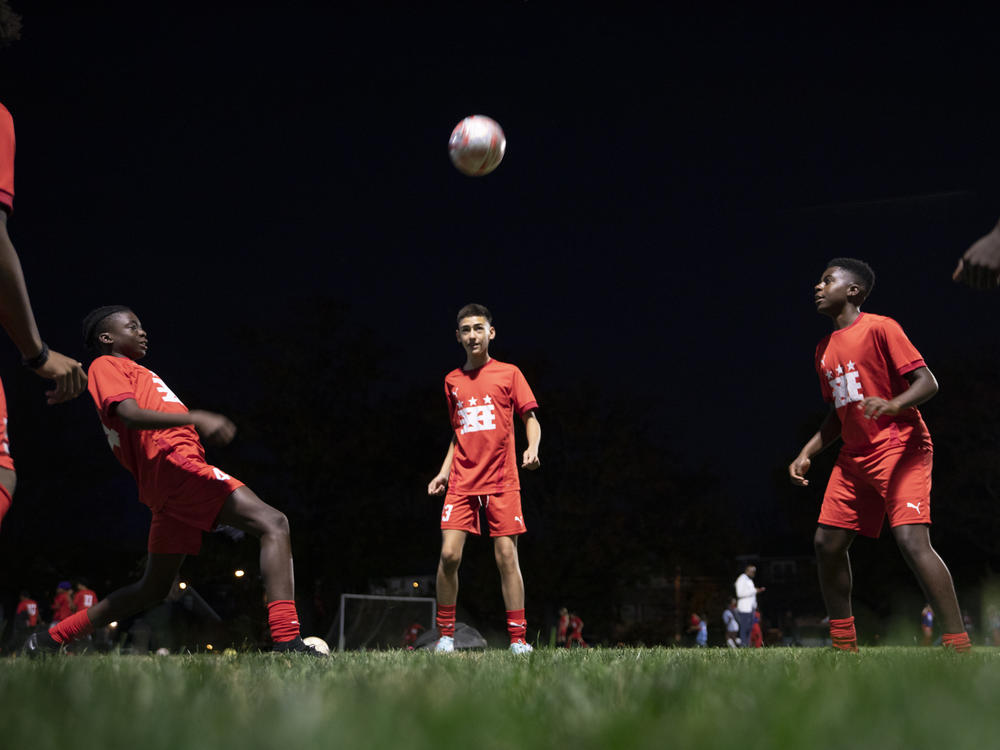 Fifteen-year-olds from a DCXI soccer team practice together in Washington, D.C., in November. Club co-founder and coach Pierre Hedji says some of their team members pay and some don't. 