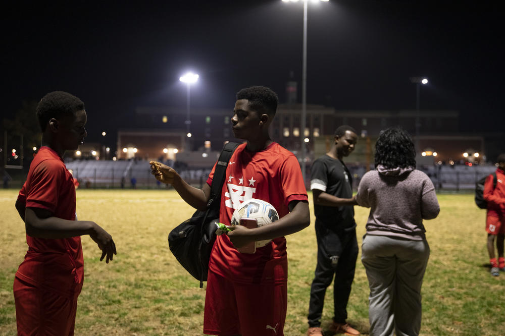 Joshua Nimley and Myko Idiokitis, from DCXI soccer team, pack up their gear after practice.