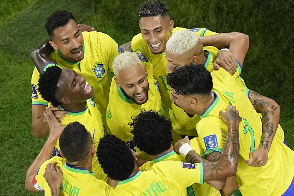 Teammates celebrate with Brazil's Neymar, center, who scored his side's second goal during a 2022 World Cup Round of 16 match with South Korea on Monday, Dec. 5, at Stadium 974 in Al Rayyan, Qatar.